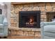 Close-up of a stone fireplace with a black firebox, offering a cozy and inviting focal point in the living room at 3849 Waycross Dr, Columbus, IN 47203