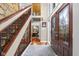Entryway with wood floors, iron railing, and decorative front door at 3849 Waycross Dr, Columbus, IN 47203