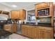 Well-lit kitchen features stainless steel appliances, wood cabinetry, and granite countertops at 3849 Waycross Dr, Columbus, IN 47203