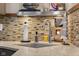 Detailed view of the kitchen counter with a mosaic backsplash, featuring sports-themed decor and modern fixtures at 3849 Waycross Dr, Columbus, IN 47203