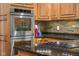 This kitchen features granite counters, stainless steel appliances and wood cabinets at 3849 Waycross Dr, Columbus, IN 47203