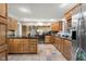 Spacious kitchen with wood cabinets, granite countertops, and stainless steel appliances at 3849 Waycross Dr, Columbus, IN 47203
