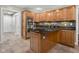 Kitchen features stainless steel appliances, center island with cooktop, and wood cabinets at 3849 Waycross Dr, Columbus, IN 47203