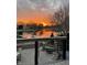 Scenic sunset view from the home's deck, overlooking the tranquil lake and landscaped grounds at 3849 Waycross Dr, Columbus, IN 47203