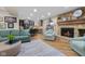 Open-concept living room with a stone fireplace, kitchen bar, comfortable seating, and plenty of natural light at 3849 Waycross Dr, Columbus, IN 47203
