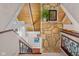 Upper level stairway features stone accent wall, wood floors, and wood railing at 3849 Waycross Dr, Columbus, IN 47203