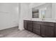 Modern bathroom featuring a double vanity, white countertops, and a large mirror reflecting the shower at 3913 Highcrest Rd, Indianapolis, IN 46239
