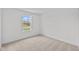 Bright bedroom featuring neutral carpet, white walls, and a single window at 3913 Highcrest Rd, Indianapolis, IN 46239