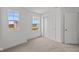 Bright bedroom with neutral carpet, closet, and white walls, offering a serene and inviting atmosphere at 3913 Highcrest Rd, Indianapolis, IN 46239