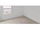 Bright bedroom featuring neutral carpet and a view of Builder's First Source at 3913 Highcrest Rd, Indianapolis, IN 46239