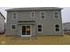 The exterior of the home showcases a gray two-story design and back patio at 3913 Highcrest Rd, Indianapolis, IN 46239