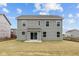 Back of a two-story home with gray siding, windows, and sliding glass door at 3913 Highcrest Rd, Indianapolis, IN 46239