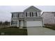 Charming two-story home with gray siding, black shutters, and an attached two-car garage at 3913 Highcrest Rd, Indianapolis, IN 46239