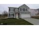 Charming two-story home with gray siding, black shutters, and an attached two-car garage at 3913 Highcrest Rd, Indianapolis, IN 46239