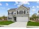 Charming two-story home featuring gray siding, black shutters, a two-car garage, and a well-manicured lawn at 3913 Highcrest Rd, Indianapolis, IN 46239