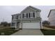 Charming two-story home with gray siding, black shutters, and an attached two-car garage at 3913 Highcrest Rd, Indianapolis, IN 46239