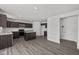 Modern kitchen featuring dark cabinetry, stainless steel appliances, an island, and sleek countertops at 3913 Highcrest Rd, Indianapolis, IN 46239