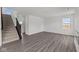Bright and airy living room featuring wood-look floors and a staircase at 3913 Highcrest Rd, Indianapolis, IN 46239