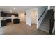 Spacious living room adjacent to kitchen features stairs to the second floor and ample lighting at 3913 Highcrest Rd, Indianapolis, IN 46239