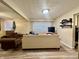 Cozy basement area perfect for relaxing, featuring a comfortable sofa and natural light from the window at 3932 Caroline Ave, Indianapolis, IN 46205