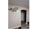 Hallway with laminate flooring, neutral walls and good lighting, offering seamless transition between rooms at 3932 Caroline Ave, Indianapolis, IN 46205