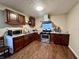 Functional kitchen with stainless steel appliances, laminate flooring, and ample cabinet space for storage at 3932 Caroline Ave, Indianapolis, IN 46205