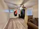 Inviting living room with laminate flooring, a ceiling fan, and ample natural light creating a comfortable space at 3932 Caroline Ave, Indianapolis, IN 46205