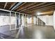 Spacious unfinished basement with painted floor and exposed wood beams ready to be customized at 4146 Roselawn Ave, Columbus, IN 47203
