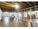 Unfinished basement space with exposed beams, painted floors, and ample potential for customization at 4146 Roselawn Ave, Columbus, IN 47203