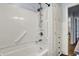 Bathroom featuring a white tub-shower with grab bars, and a large storage cabinet at 4146 Roselawn Ave, Columbus, IN 47203