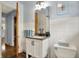 Bright bathroom features granite counters, a white toilet, and wainscotting at 4146 Roselawn Ave, Columbus, IN 47203