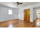 Bedroom features hardwood floors, a ceiling fan, and natural light at 4146 Roselawn Ave, Columbus, IN 47203
