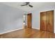 Open bedroom featuring hardwood flooring, a ceiling fan and wood doors at 4146 Roselawn Ave, Columbus, IN 47203