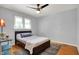 Cozy bedroom with hardwood floors, ceiling fan, and ample natural light at 4146 Roselawn Ave, Columbus, IN 47203