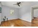 Well-lit bedroom features hardwood flooring, neutral walls, a ceiling fan, and natural lighting at 4146 Roselawn Ave, Columbus, IN 47203
