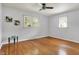 Neutral bedroom features hardwood floors, ample natural light, and a ceiling fan at 4146 Roselawn Ave, Columbus, IN 47203