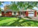 Charming red brick ranch-style home with attached garage, manicured lawn, and well-maintained landscaping at 4146 Roselawn Ave, Columbus, IN 47203