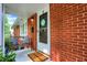 Cozy front porch with bench seating, a welcome mat, and brick siding at 4146 Roselawn Ave, Columbus, IN 47203