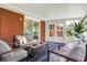 Comfortable sunroom with brick accent wall, neutral decor, and serene atmosphere at 4146 Roselawn Ave, Columbus, IN 47203