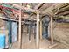 Unfinished basement with exposed beams, ductwork, and a newer hot water heater at 435 N Chestnut St, Monrovia, IN 46157