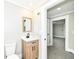 Bathroom featuring a modern sink, wood-look vanity, and access to another room at 435 N Chestnut St, Monrovia, IN 46157
