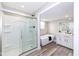 Modern bathroom with separate shower and tub, vanity with sink, and wood-look flooring at 435 N Chestnut St, Monrovia, IN 46157