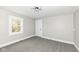Bright and airy bedroom with neutral walls, carpet, and a window overlooking a green area at 435 N Chestnut St, Monrovia, IN 46157