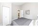 Bedroom with gray carpet and open door to what appears to be a kitchen at 435 N Chestnut St, Monrovia, IN 46157