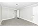 Bright, empty bedroom with neutral walls, carpet, a doorway to another room and a window at 435 N Chestnut St, Monrovia, IN 46157