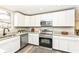 Bright, modern kitchen features stainless steel appliances, granite countertops, and white cabinetry at 435 N Chestnut St, Monrovia, IN 46157