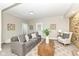 Bright living room featuring a stone fireplace, recessed lighting, and a comfortable gray sofa at 435 N Chestnut St, Monrovia, IN 46157