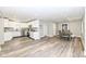 Open-concept living and dining area with modern kitchen, white cabinets and wood-look floors at 435 N Chestnut St, Monrovia, IN 46157