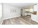 Open-concept living room and kitchen with modern finishes and wood-look flooring at 435 N Chestnut St, Monrovia, IN 46157