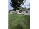 Stone path in a large yard showcasing green grass connecting detached garage to the main house at 4904 Betholm Dr, Indianapolis, IN 46239